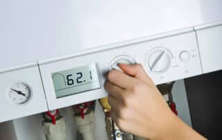 Thermostat settings being checked after a storm when the boiler won’t ignite.
