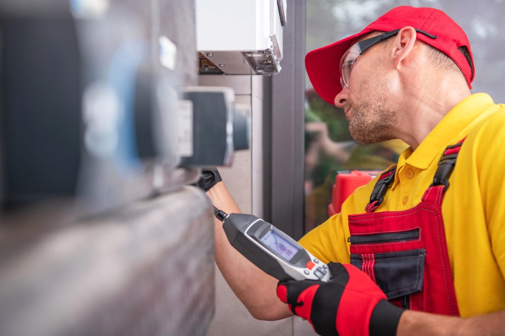 Cardom Plumbing & Heating technician inspecting gas system with diagnostic tool – reliable gas leak detection services in Arvada homes and businesses.