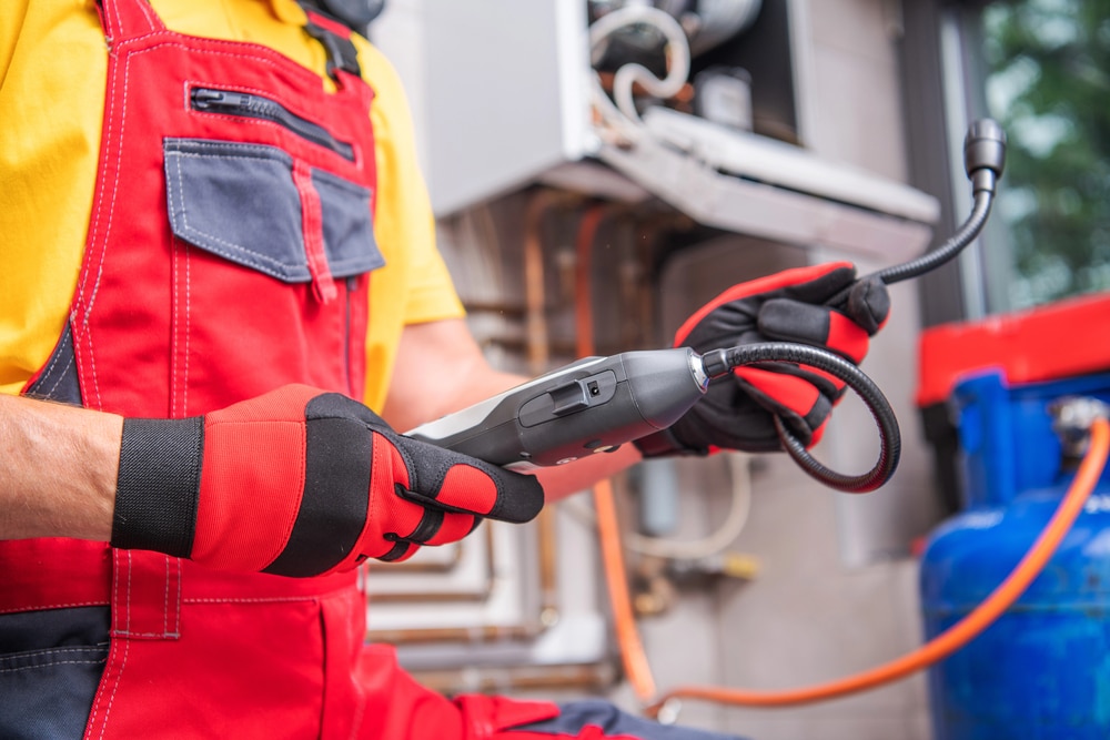 Cardom Plumbing & Heating technician checks furnace with diagnostic tool – trusted gas leak repair services for homes and businesses in Arvada.