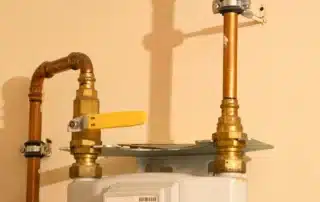 Gas line basics for homeowners covering proper sizing, approved materials, and permit rules, shown with a copper gas pipe and shutoff valve to highlight safety requirements, code compliance, and reliable fuel delivery in residential systems.