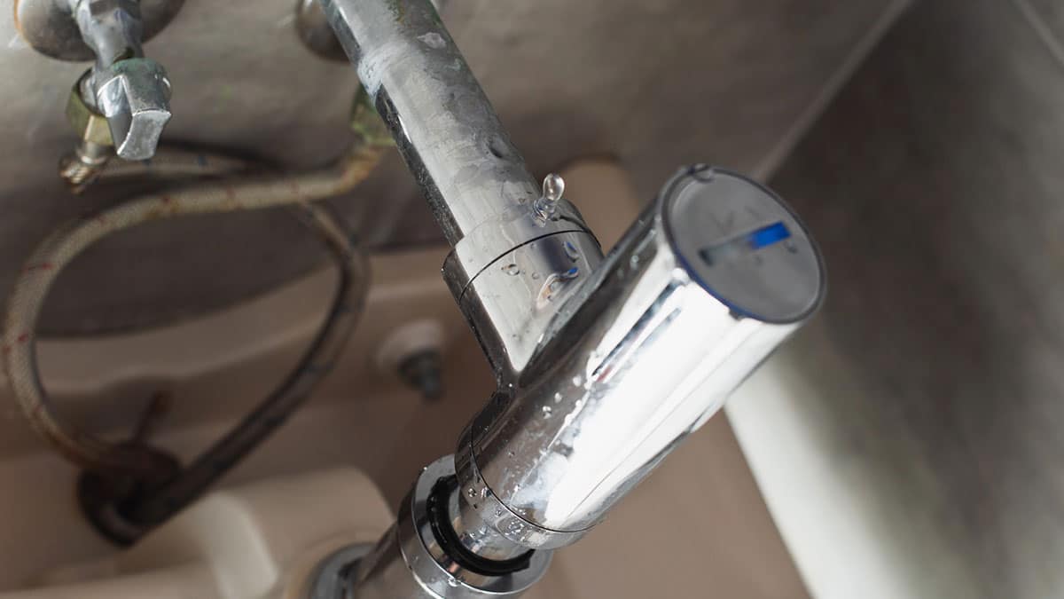 Metal faucet with visible plumbing underneath