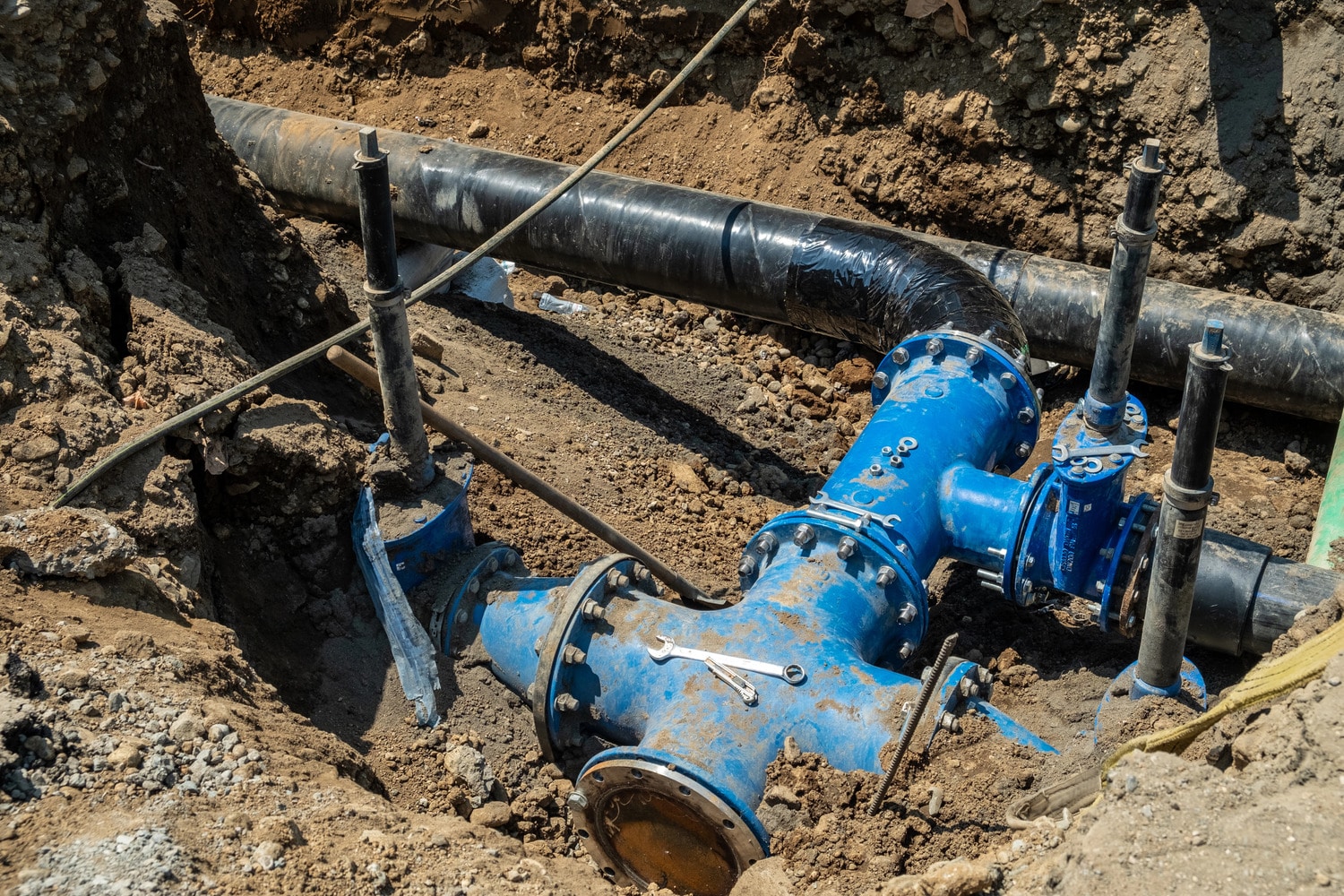 Cardom Plumbing and Heating explains the Pros and Cons of Trenchless Sewer Repair. Underground water pipe installation with blue fittings for sewers.