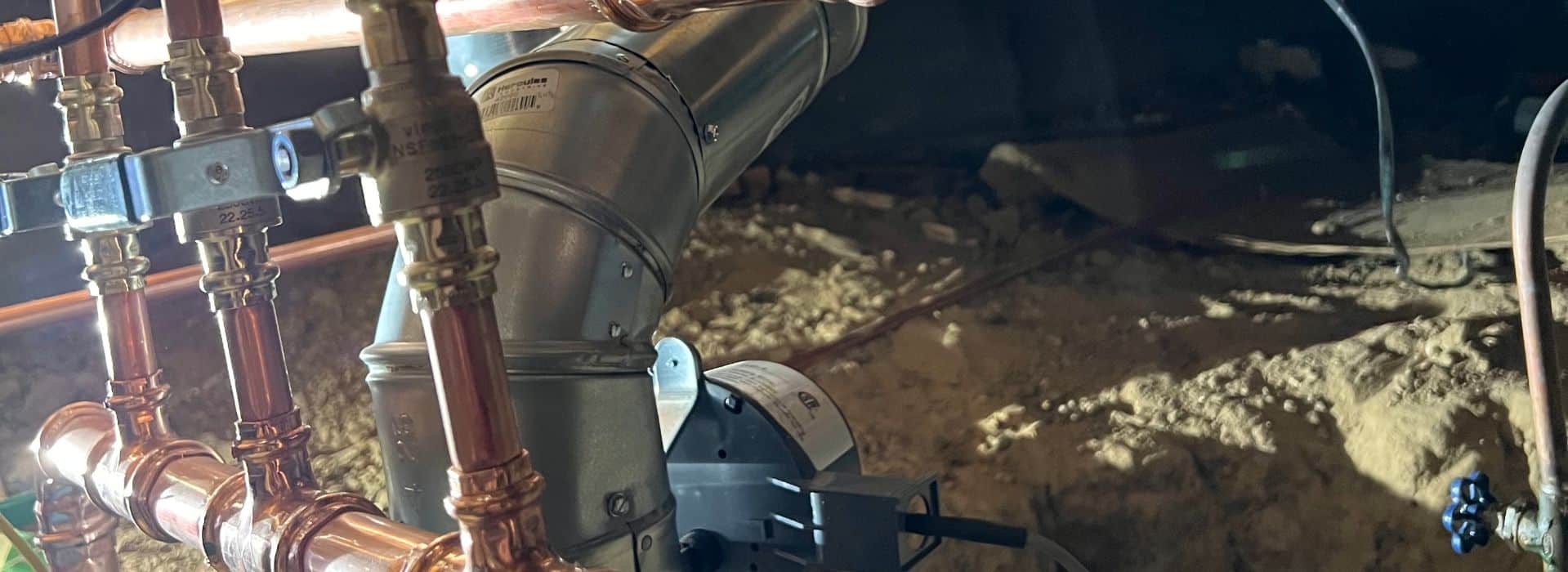 Close-up of copper pipes in a basement.